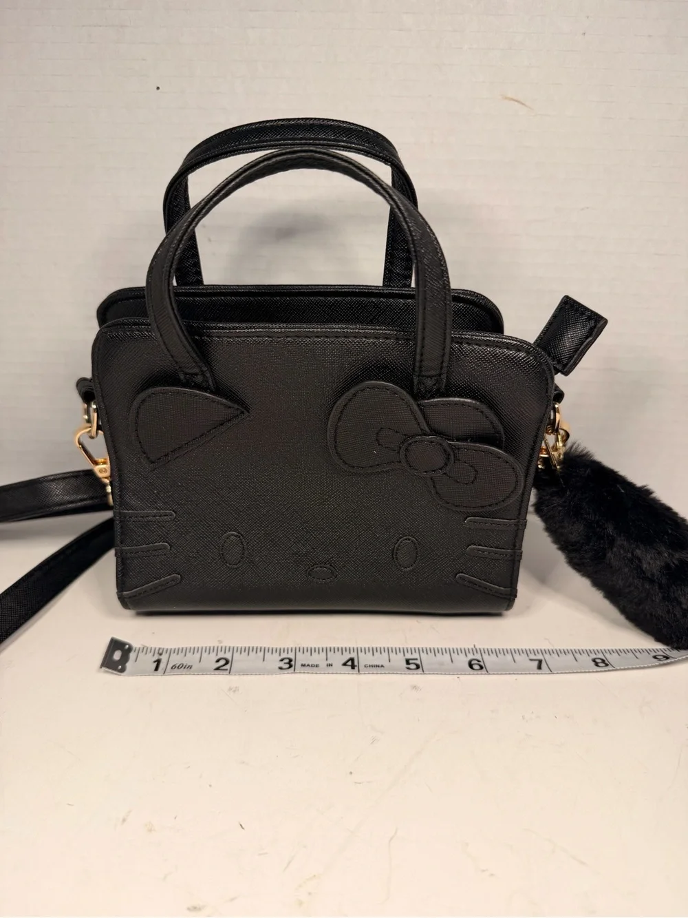 Sanrio Hello Kitty Black Faux Leather Crossbody Handbag with Pom Pom Charm